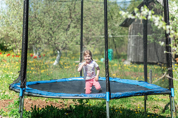 istock Little girl jumping on the trampoline 611593780