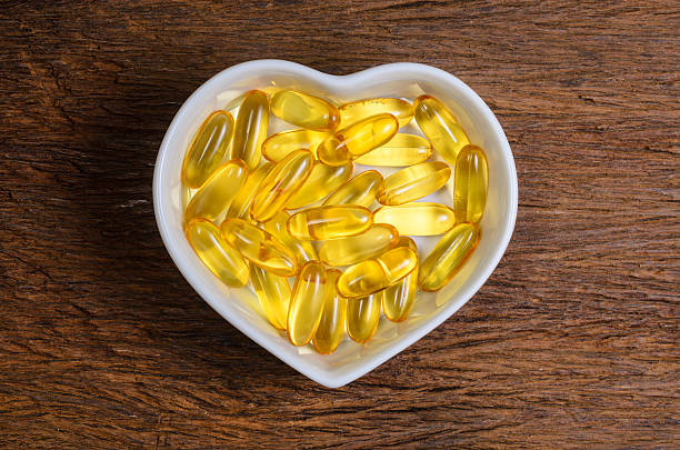 istock fish oil in heart shape bowl 611595822