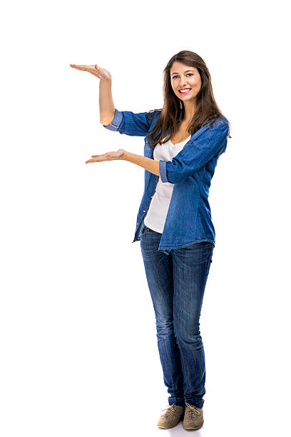 istock Beautiful woman showing something over a white background 611596478