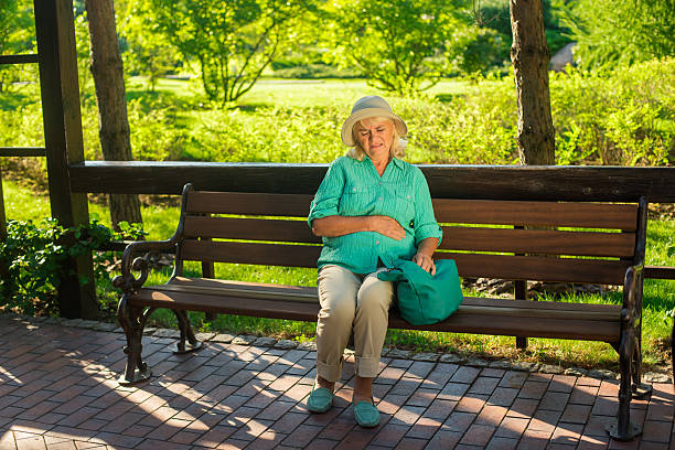 istock Mature woman has stomach ache. 611599760