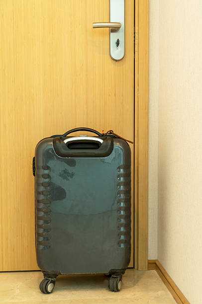 istock luggage behind door 611600198