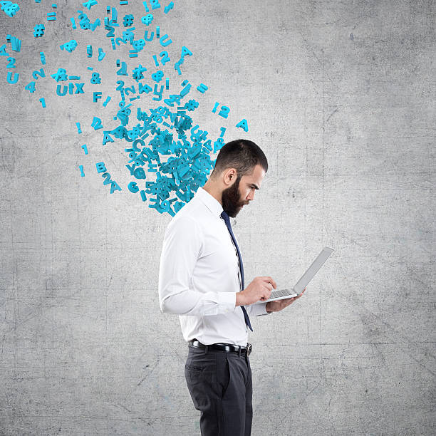 istock Businessman working on laptop with flying alphabets 611601358