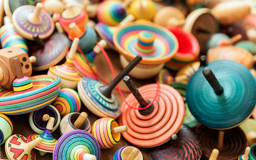 Artisanal wooden colorful spinning tops