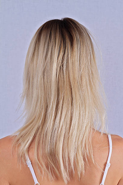 istock Woman with blonde damaged hair, split ends 611603354