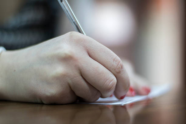 istock Woman at office desk signing a contract 611603446