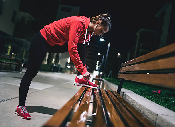 istock Young woman preparing for midnight run 611604746