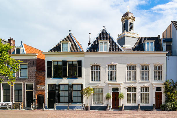 Old houses in Leiden, Netherlands Leiden, Netherlands - August 9, 2016: Row of historic gables of houses on Stille Rijn in old town of Leiden, South Holland, Netherlands dutch culture photos stock pictures, royalty-free photos & images