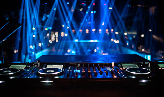 Group of young people, girls attending party, dancing, having fun over dark background in neon with mixed light. Concept of youth culture, leisure time activity, fun, lifestyle, celebration