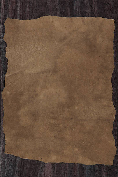 istock old paper on wooden background. 611606674