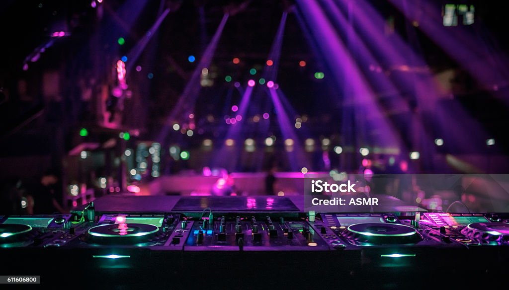 DJ console mixing desk at a night club Nightclub Stock Photo