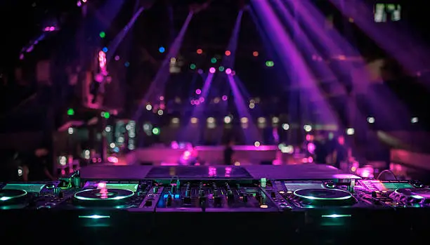 Photo of DJ console mixing desk at a night club