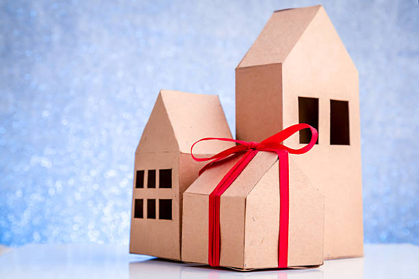 istock house in brown recycled paper on white floor 611606864