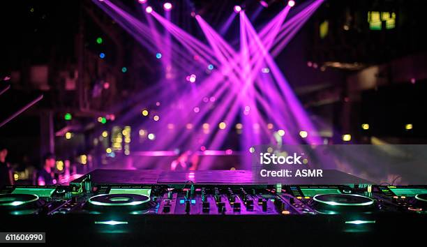 Dj Console Mixing Desk At A Night Club Stock Photo - Download Image Now - DJ, Illuminated, Lighting Equipment