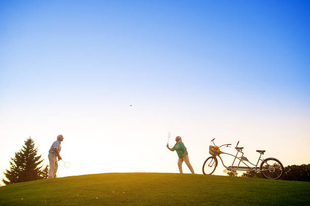istock Elderly couple playing badminton. 611608242
