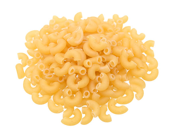 istock heap of Elbow macaroni pasta isolated on white background 611608596