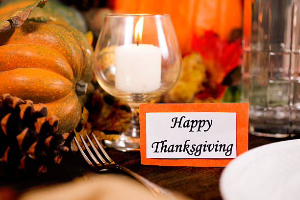 istock Happy Thanksgiving place setting with autumn centerpiece on table. 611609936