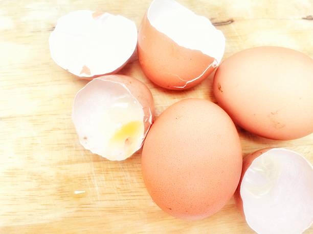 istock Fresh eggs and egg shells laying on the wooden floor 611610864