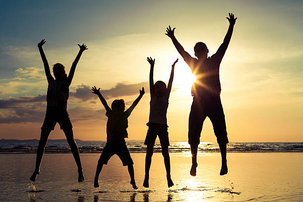 istock Father and children playing on the beach at the sunset 611611144