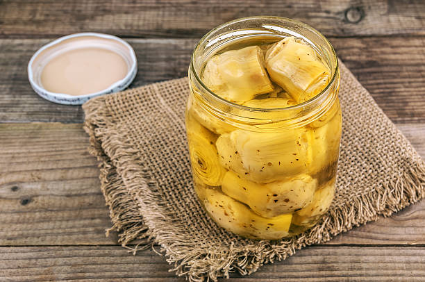 Artichokes in olive oil. Open glass jar