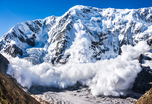 Power of nature. Real huge avalanche comes from a big mountain (Shkhara, 5,193 m), Caucasus, Kabardino-Balkaria, Bezengi region, Russia