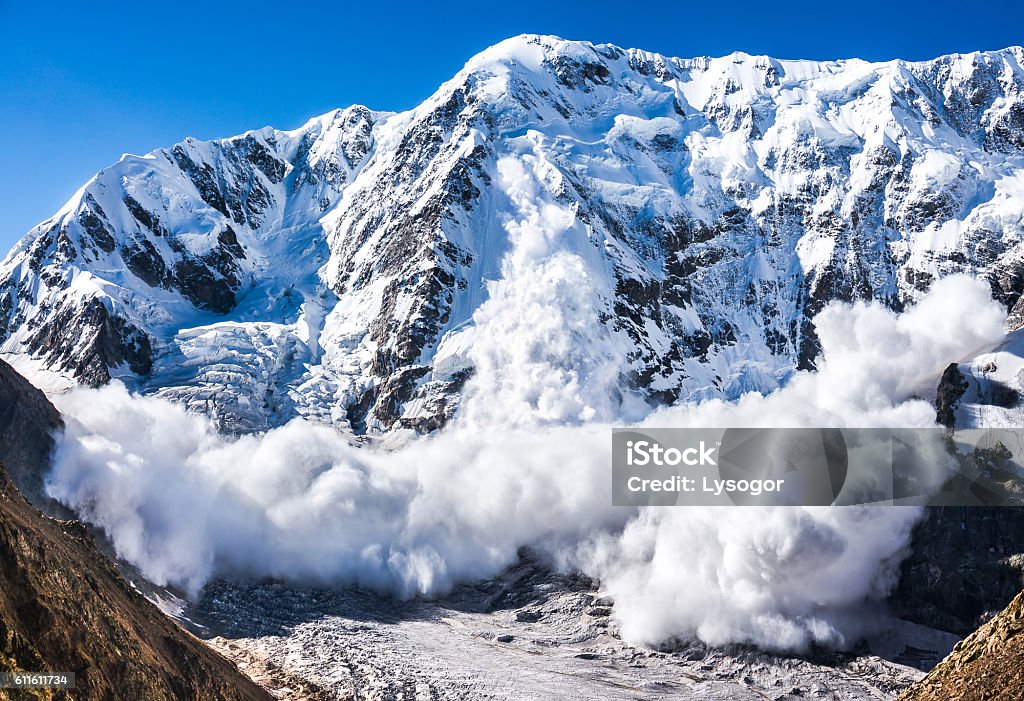 Power of nature. Avalanche in the Caucasus Power of nature. Real huge avalanche comes from a big mountain (Shkhara, 5,193 m), Caucasus, Kabardino-Balkaria, Bezengi region, Russia Avalanche Stock Photo
