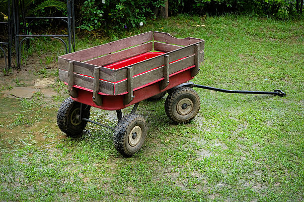 istock Red wagon small size on a green lawn 611614144