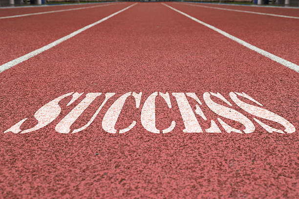 istock success written on the red running track 611614834
