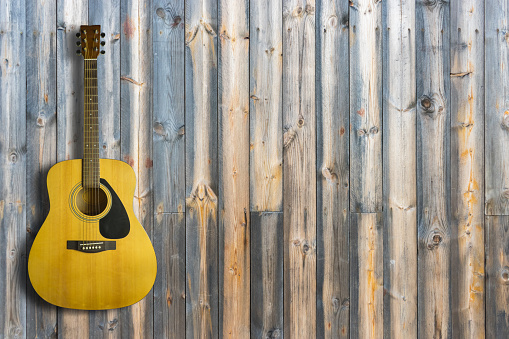 Acoustic guitar on wooden background texture.Copy space