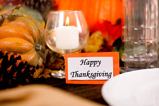 istock Happy Thanksgiving place setting with autumn centerpiece on table. 611615398