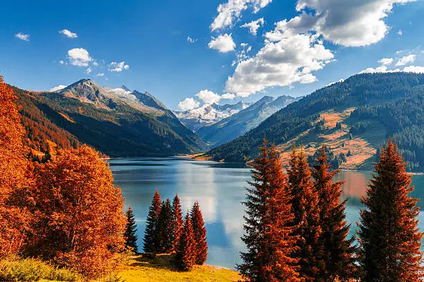 Autumn view with red foliage of Alps with lake in Tyrol, Austria