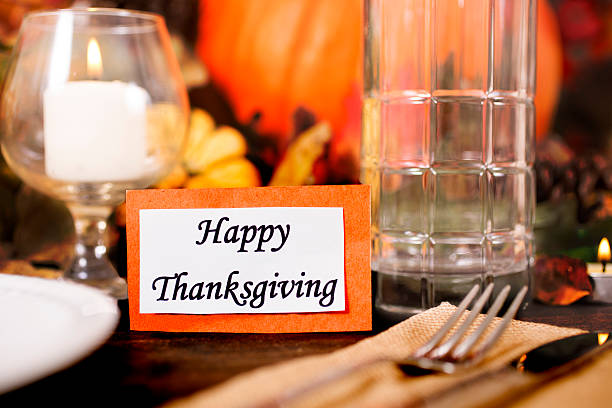 istock Happy Thanksgiving place setting with autumn centerpiece on table. 611617826