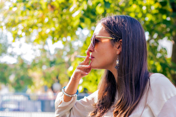 istock woman smoking a cigarette 611619836