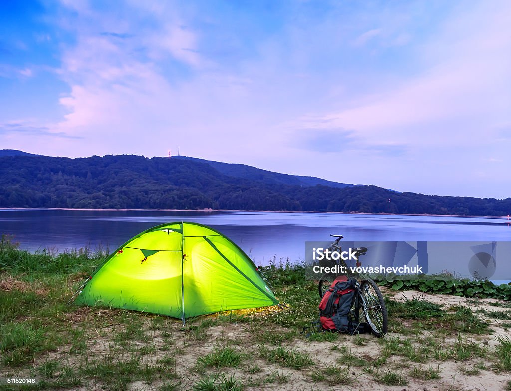 tent and bike tent and bike on the lake after sunset Bicycle Stock Photo