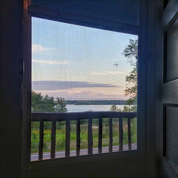 istock Lake Champlain Adirondack Rustic Porch Rail Screen Door Open View 611620918