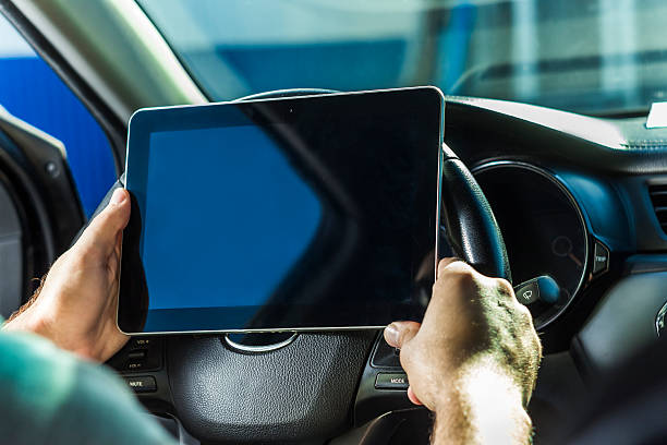 istock The man in the car, with the Tablet in hands 611623240