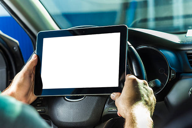 istock The man in the car, with the Tablet in hands 611623274