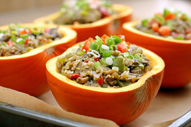 istock Autumn stuffed pumpkin with rice and mushrooms ready to bake 611623804