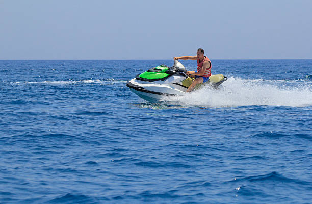 istock Tourists enjoy driving jetski on the ocean 611624890