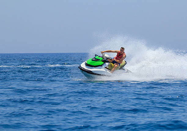 istock Tourists enjoy driving jetski on the ocean 611624972