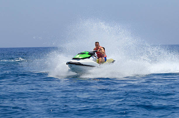 istock Tourists enjoy driving jetski on the ocean 611625056