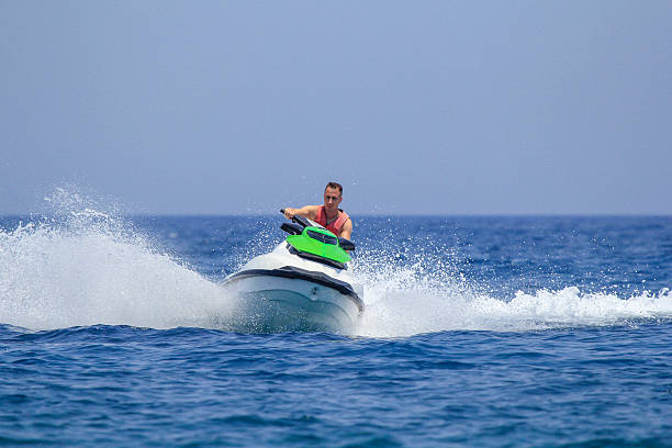 istock Tourists enjoy driving jetski on the ocean 611625288