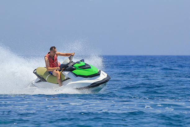 istock Tourists enjoy driving jetski on the ocean 611625372