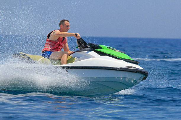 istock Tourists enjoy driving jetski on the ocean 611625676