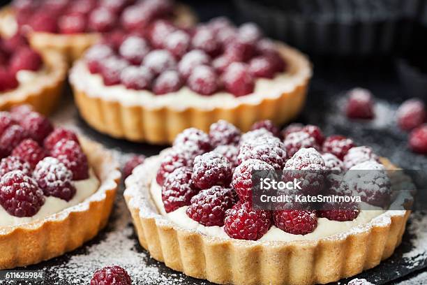 Delicious Raspberry Mini Tarts On Dark Background Stock Photo - Download Image Now - Dessert - Sweet Food, Baked Pastry Item, Pastry Dough