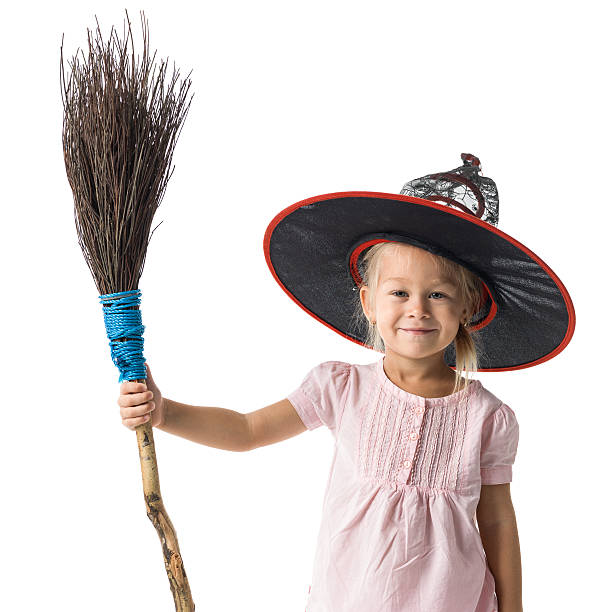 istock Little girl with witch's hat and real broom 611627124