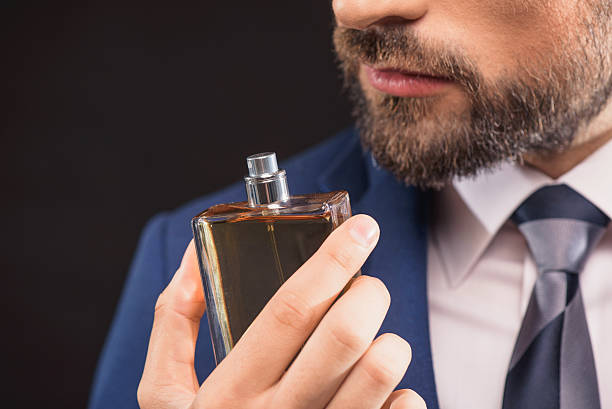 Successful businessman likes perfume scent stock photo