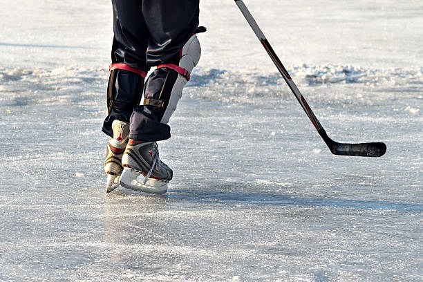 istock Hockey player practising on a frozen pond 611629308