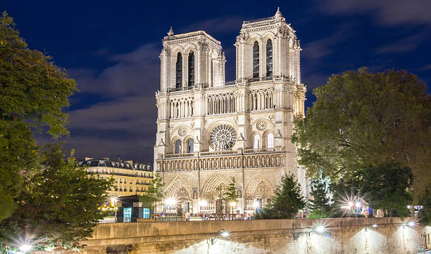 istock The Notre Dame cathedral at night, Paris. 611629976