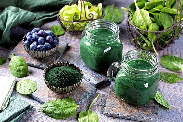 Green smoothie Green smoothie with spirulina,spinach and blueberries antioxidant photos stock pictures, royalty-free photos & images
