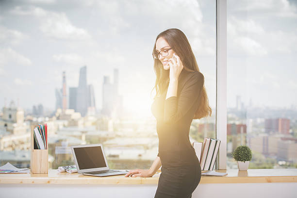 istock Woman on phone with laptop 611632442